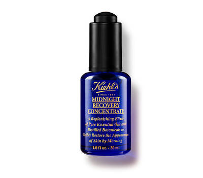 Blue glass bottle of Kiehl's Midnight Recovery Concentrate, a skincare oil designed to restore skin's appearance overnight.