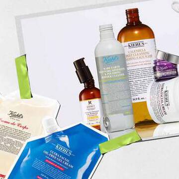 En samling av Kiehl's hudpleieprodukter, inkludert kremer og serum, kunstnerisk arrangert med levende emballasje og synlige etiketter.