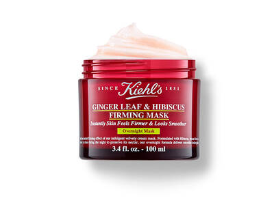 A red jar of Kiehl's Ginger Leaf & Hibiscus Firming Mask, featuring a light pink cream and labeled for overnight use.