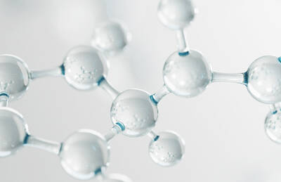 Close-up of transparent molecular structures, featuring spherical shapes interconnected by slender links, creating a sense of depth and scientific detail.