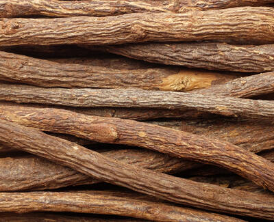 A close-up of various brown sticks, showcasing their rough texture and natural patterns, arranged tightly together.