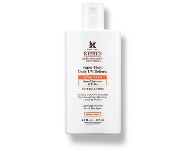 A bottle of Kiehl's Super Fluid Daily UV Defense sunscreen, featuring SPF 50 and anti-pollution benefits.