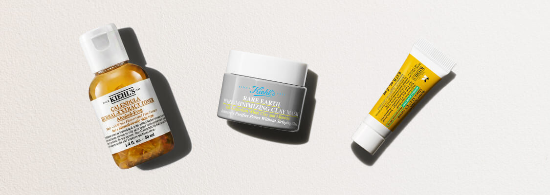 Tre hudpleieprodukter fra Kiehl's på en lys bakgrunn: Calendula-toner, Rare Earth-leirmaske og en liten gul tube.