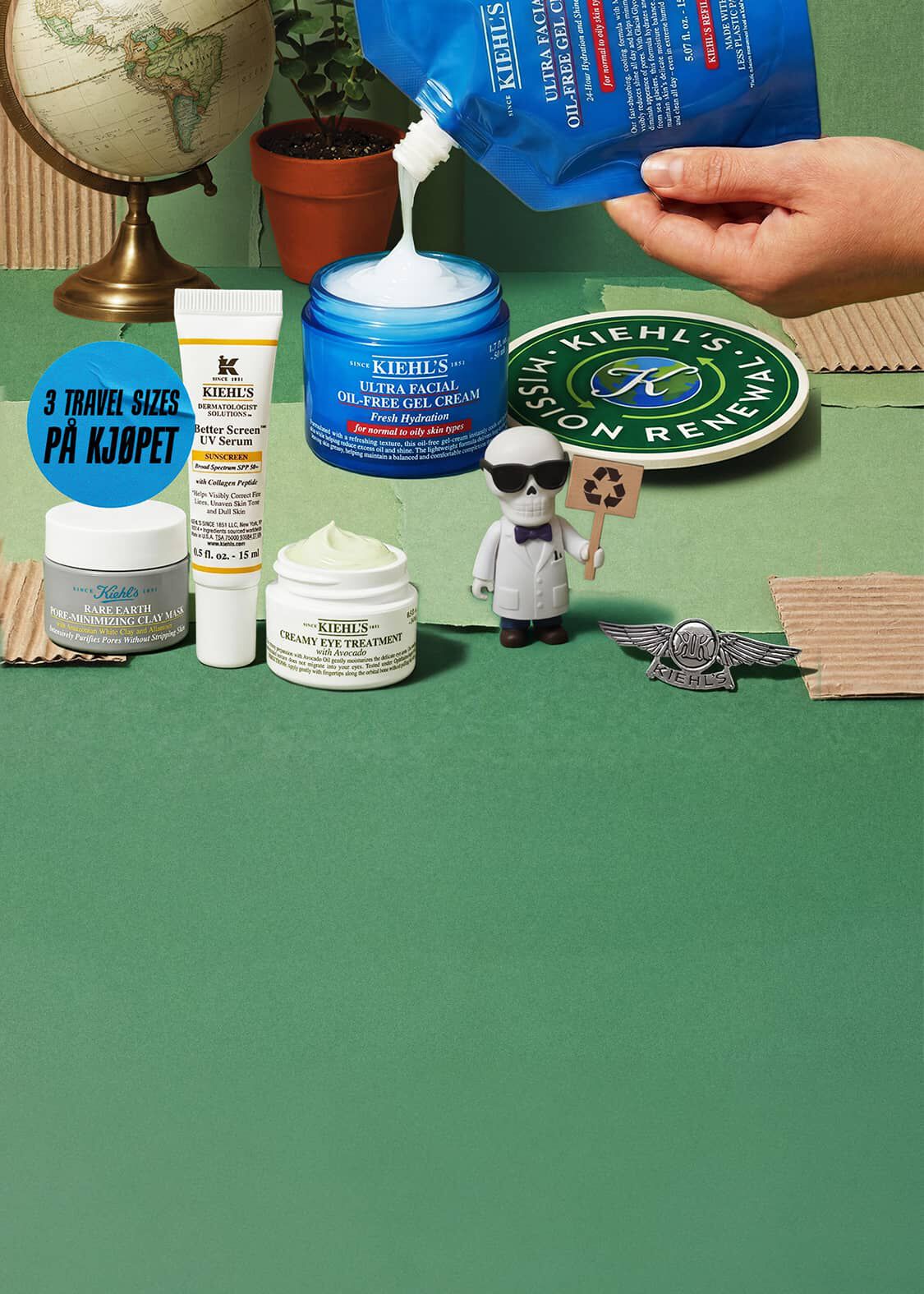 Hender som heller Kiehl's Ultra Facial Oil-Free Gel Cream med andre Kiehl's hudpleieprodukter, en globus, en plante og en liten figur på grønn bakgrunn.