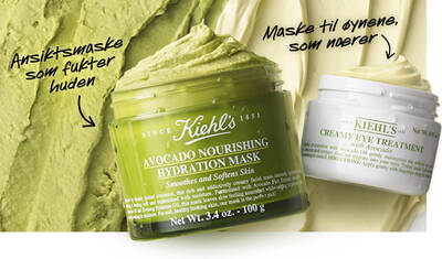 Close-up of two skincare products: a green jar labeled "Avocado Nourishing Hydration Mask" for smoothing and hydrating the skin, and a white jar labeled "Creamy Eye Treatment" for nourishing the eye area, set against a textured green backdrop.