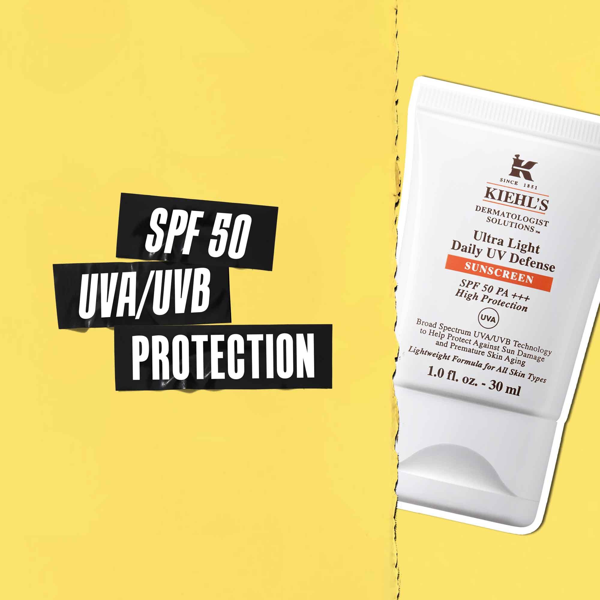 Utheving av SPF 50 UVA/UVB-beskyttelse på svart tape med et bilde av Ultra-Light Daily UV Defense-tuben ved siden av.
